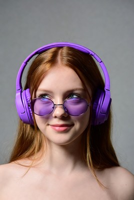 Redhead woman wearing purple headphones
