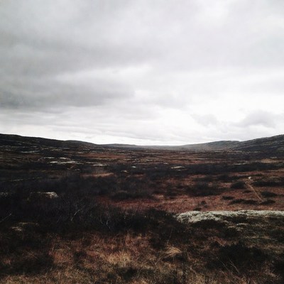Cloudy tundra landscape with rocky hills
