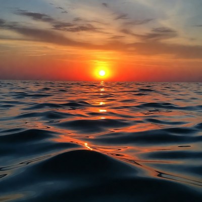 Sunset over Calm Ocean Waves