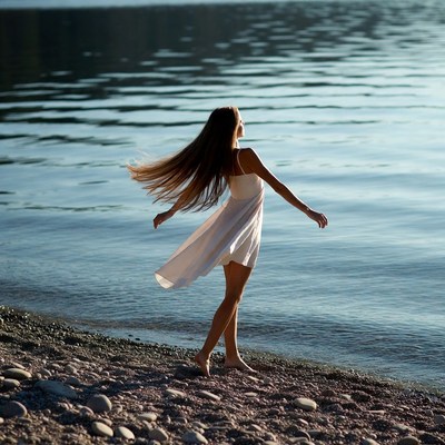 Woman in white dress by lake
