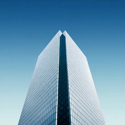 Tall Glass Skyscraper Against Blue Sky