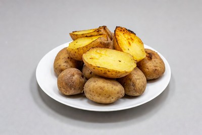 Roasted potatoes on white plate