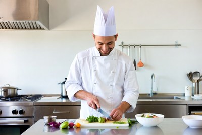 Chef chopping vegetables on kitchen counter