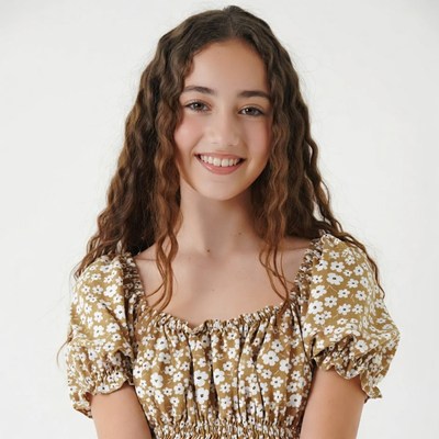 Smiling girl in floral off-shoulder top