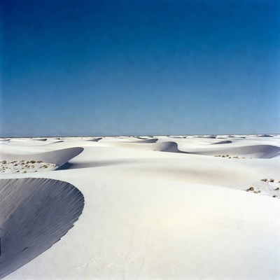 White sand dunes under blue sky