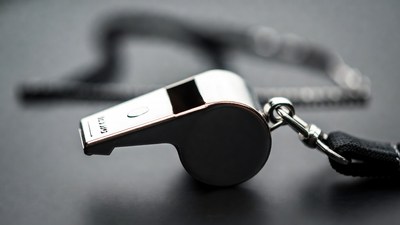 Silver whistle with black lanyard