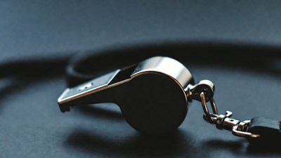 Silver whistle with black lanyard