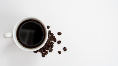 White Cup of Black Coffee with Beans