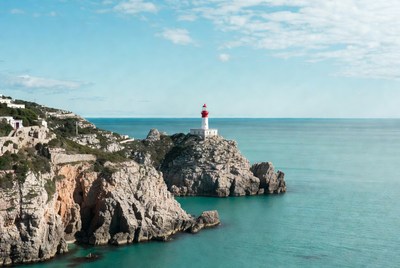 White lighthouse on coastal cliffs