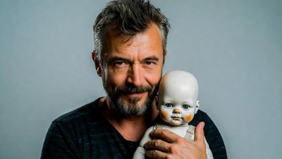 Man holding porcelain doll