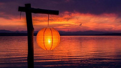 Orange paper lantern sunset lake