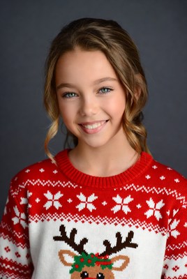 Girl smiling in reindeer Christmas sweater