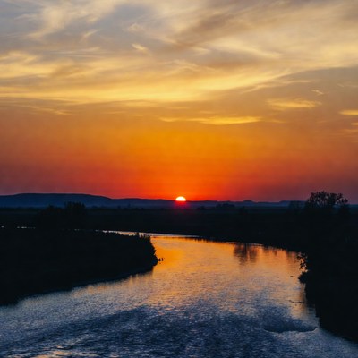 Sunset over river and mountains