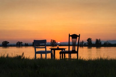 Chairs and Table at Sunset by Lake