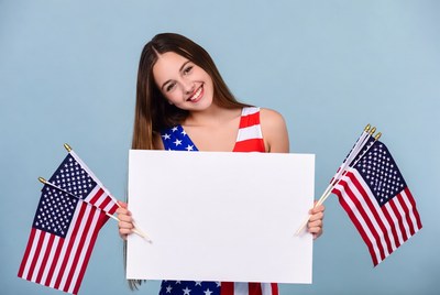 Girl holding blank sign with American flags