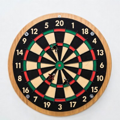 Dartboard with darts on wall