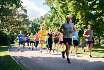 Group of runners jogging on park path
