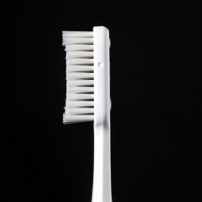 White toothbrush on black background