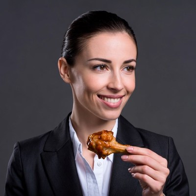 Woman eating chicken wing