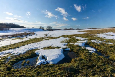Snowy Field Under Blue Sky