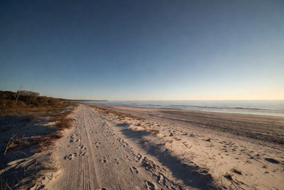 Sandy beach track at sunset