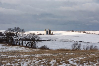 Grain Silos in Snowy Winter Field
