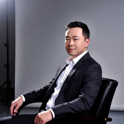 Asian man in suit sitting