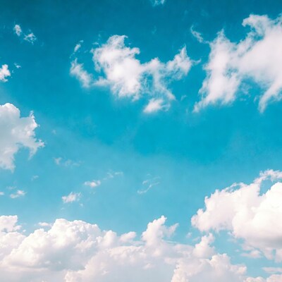 Fluffy white clouds in blue sky