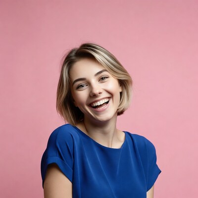 Smiling woman in blue top on pink background