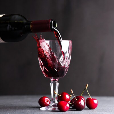 Red Wine Pouring into Crystal Glass