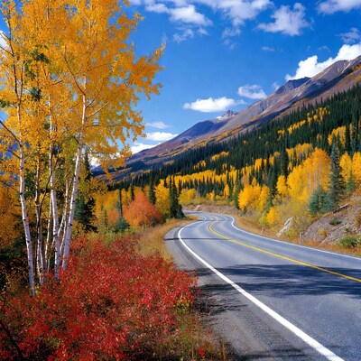 Winding road through autumn mountains