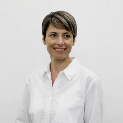 Smiling woman with short hair in white shirt