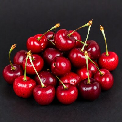 Fresh red cherries on black background