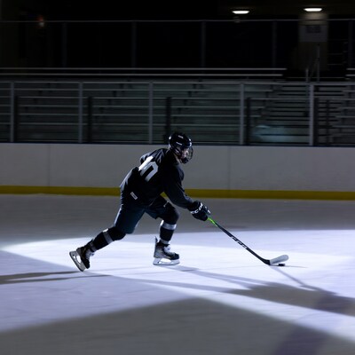 Hockey player shooting puck on ice