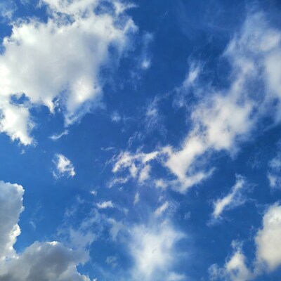 Fluffy white clouds in blue sky