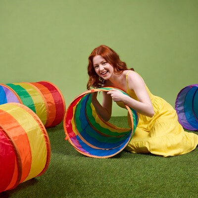 Redhead woman playing with rainbow tunnel