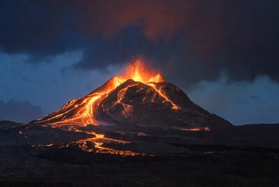 Erupting volcano with glowing lava flows