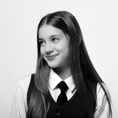 Girl in school uniform smiling sideways