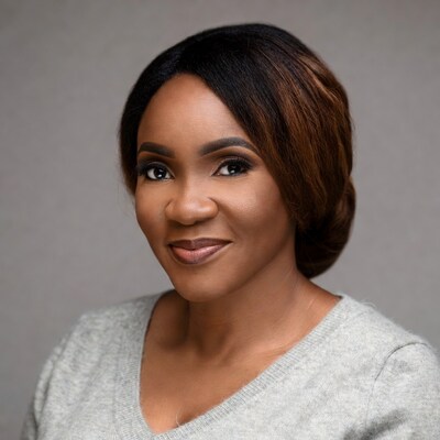 African-American woman smiling in gray sweater