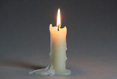 Burning Candle with Dripping Wax