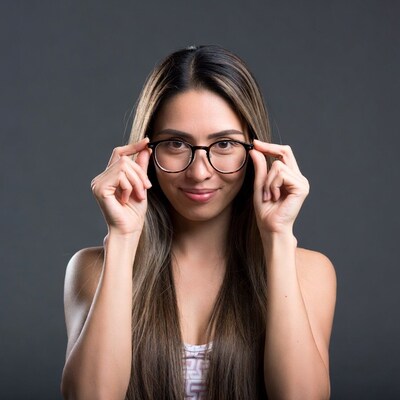 Asian woman adjusting glasses
