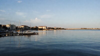 Boats docked at marina with buildings