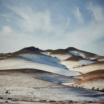 Snow-dusted rolling hills landscape