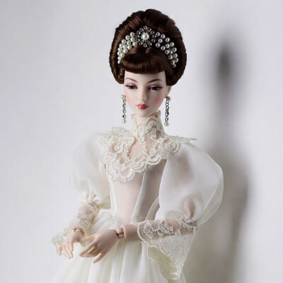 Elegant doll in white lace gown