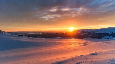 Snowy Mountain Sunset with Sun