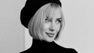 Blonde woman in beret smiling