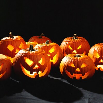 Jack-o'-lantern pumpkins on black background