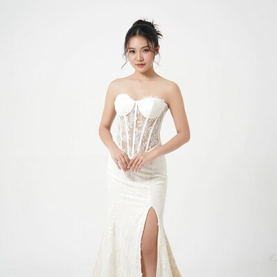 Asian woman in white lace gown
