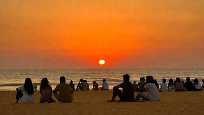 Group watching sunset on beach