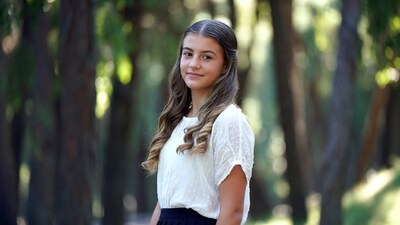 Teen girl smiling in forest